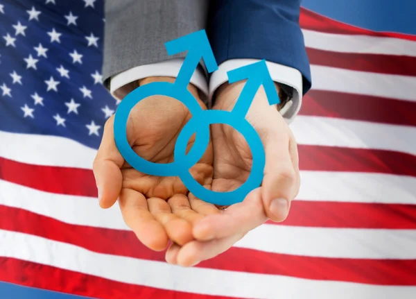 Close up of happy male gay couple with love symbol — Stock Photo, Image