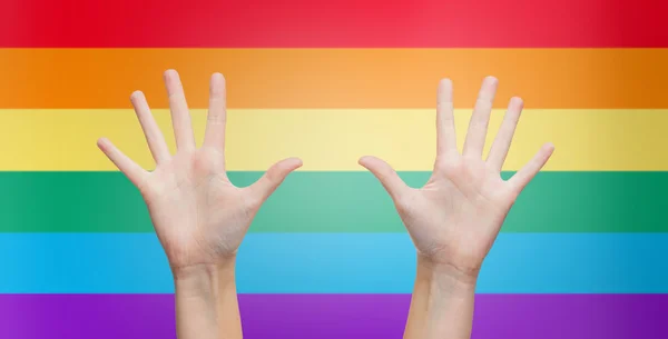 Palms of human hands thumbs up over rainbow — Stockfoto