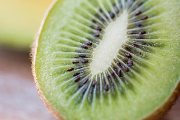 Close up of ripe kiwi slice on table — Stock Photo, Image