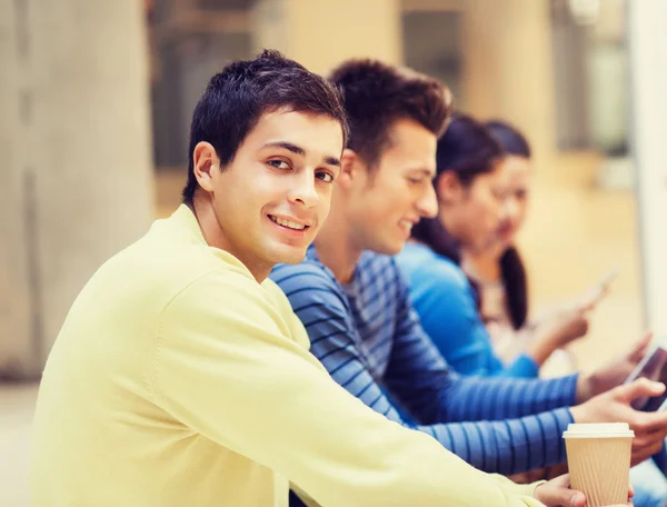 Group of students with tablet pc and coffee cup — Stock Photo, Image