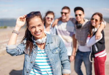 teenage girl with headphones and friends outside clipart