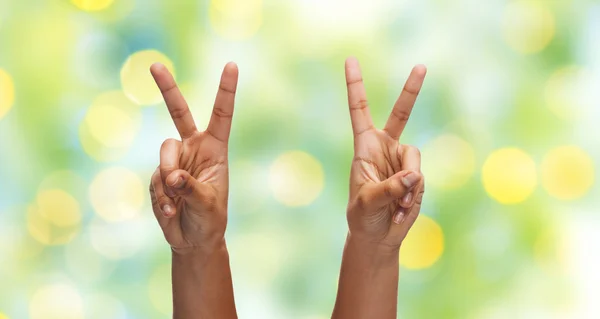 Two african hands showing victory or peace sign — Stok fotoğraf