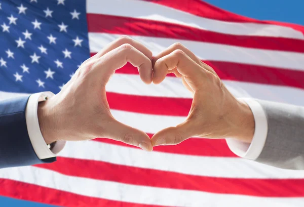 Close up of male gay couple hands showing heart — Stock Photo, Image