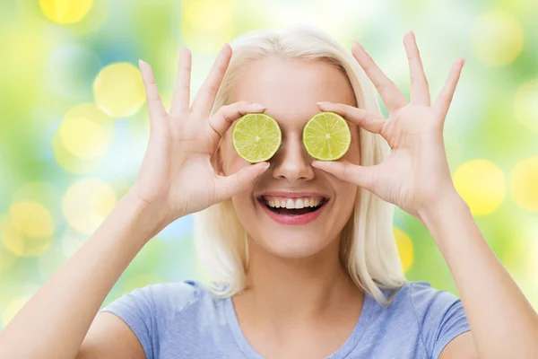 Happy woman having fun covering eyes with lime — Stock fotografie
