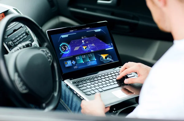 Man using navigation on laptop computer in car — Stockfoto