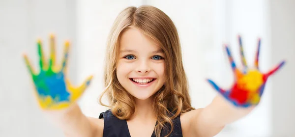 Girl showing painted hands — Stock Photo, Image