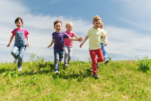 Group of happy kids running outdoors — Stock Photo, Image