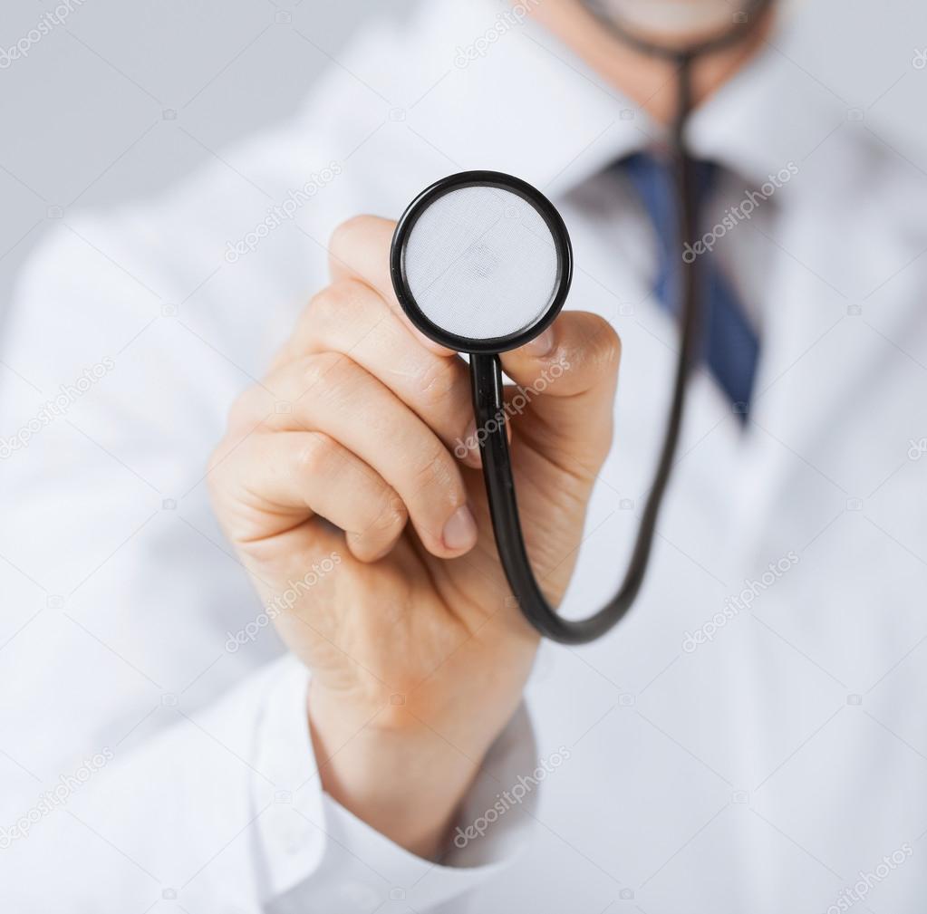 Doctor hand with stethoscope listening something — Stock Photo © Syda
