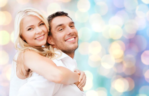 Happy couple hugging over holidays lights — Stok fotoğraf
