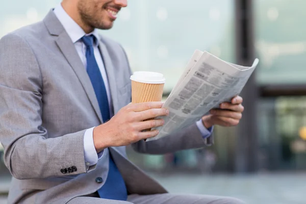 Close up of smiling businessman reading newspaper — Stock Photo, Image