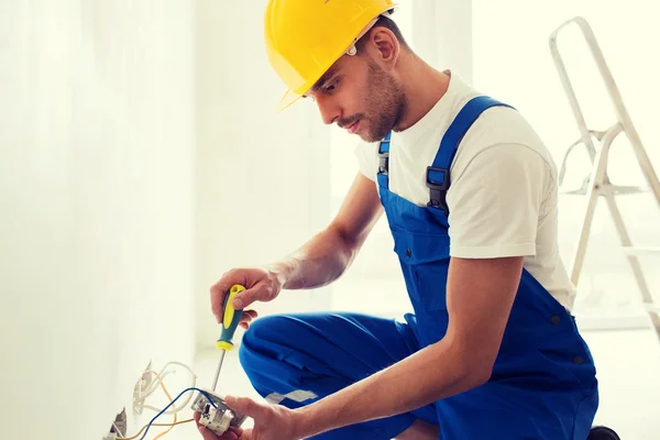 Builder with tablet pc and equipment indoors — Stock Photo, Image