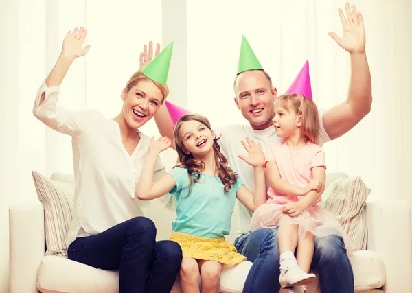 Happy family with two kids in hats celebrating — Stock Photo, Image