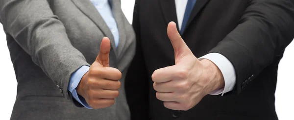 Businessman and businesswoman showing thumbs up — Stock Photo, Image