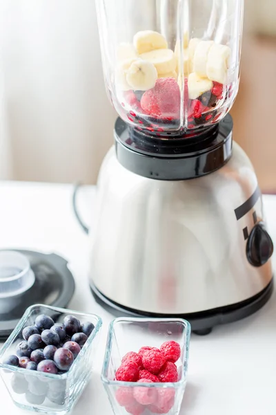 Close up of blender with berries and fruits — Stock Fotó
