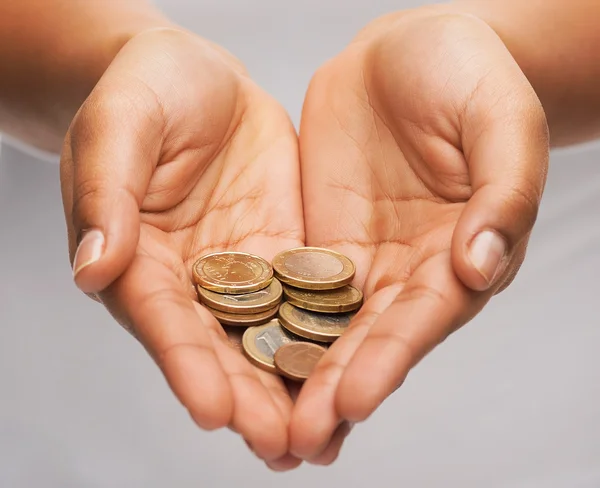 Womans cupped hands showing euro coins — Stock Photo, Image