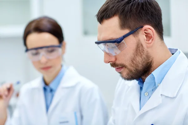 Close up of young scientists at laboratory — Stock Photo, Image