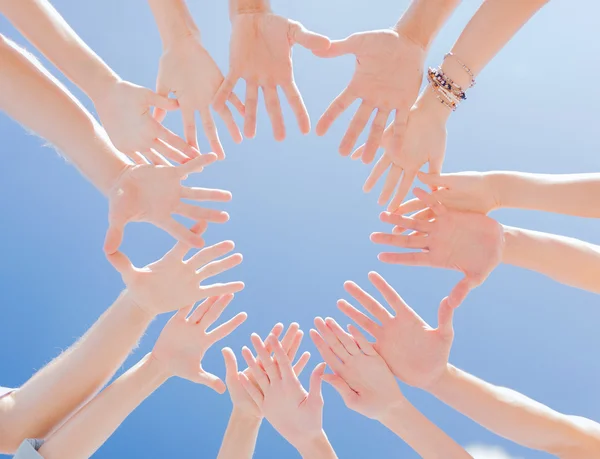 Many hands over blue sky background — Stock Photo, Image