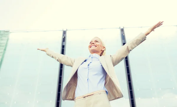 Young smiling businesswoman over office building — Stock Photo, Image