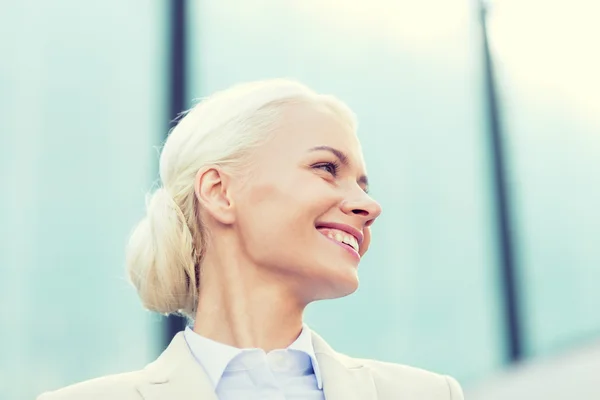 Jeune femme d'affaires souriante sur immeuble de bureaux — Photo