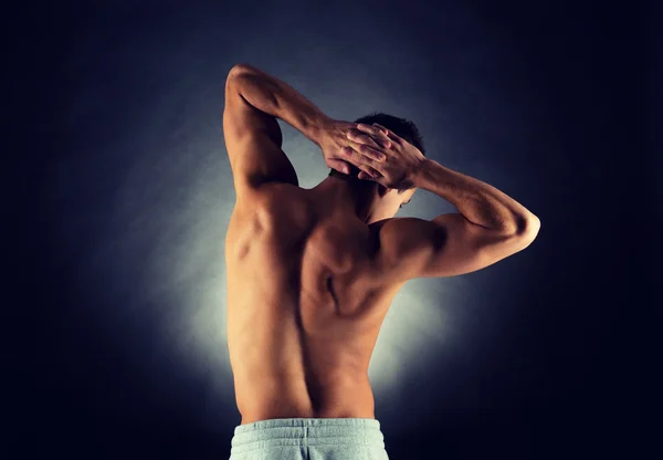 Young male bodybuilder from back — Stock Photo, Image
