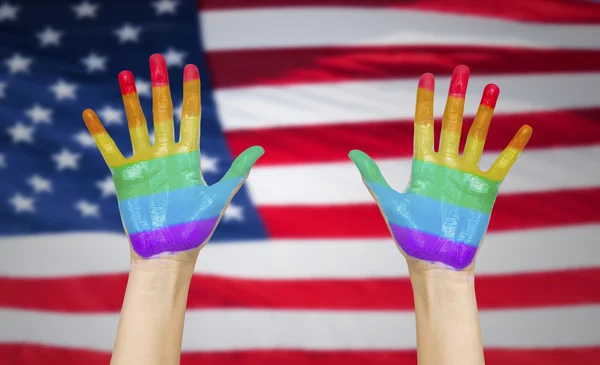 Hands painted in rainbow colours and american flag — ストック写真