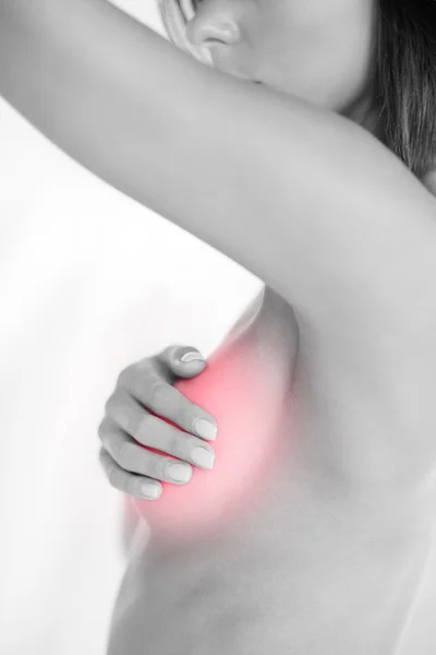 Woman checking breast for signs of cancer — Stock Photo, Image