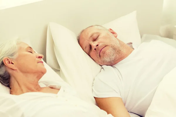 Happy senior coupler lying in bad at home — Stock Photo, Image