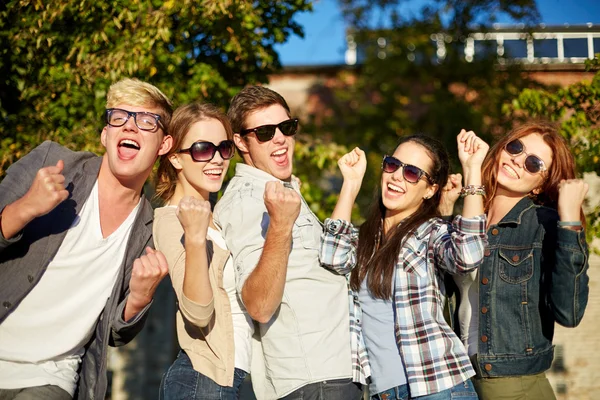 Group of happy friends showing triumph gesture — Stock Photo, Image