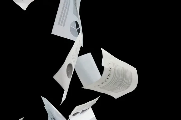 Business papers falling down over black background — Stockfoto