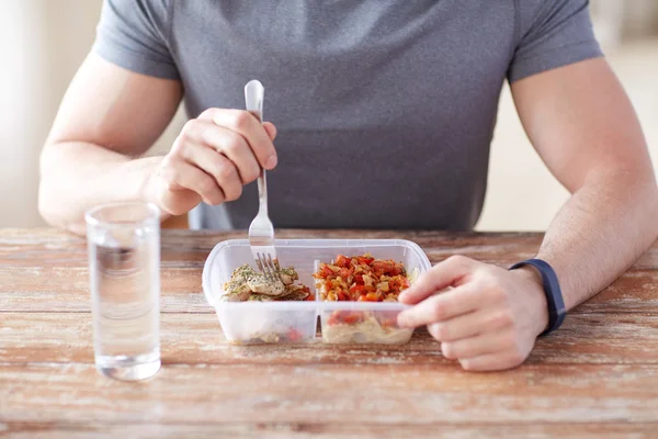 Close up of man with fork and water eating food — Stock Photo, Image