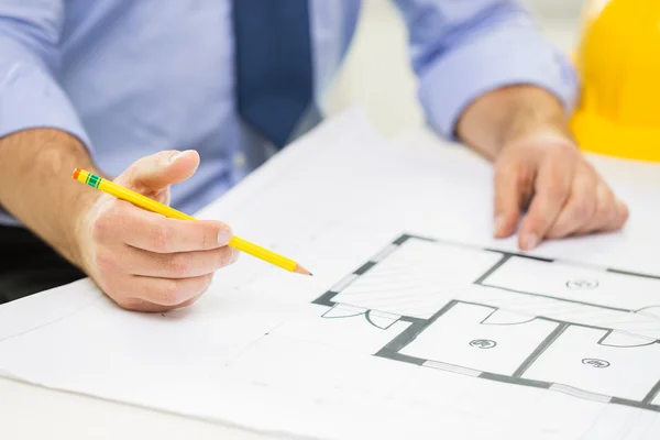 Close up of male hand with blueprint and pencil — Stock Photo, Image