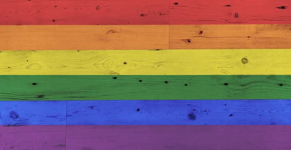 Gay pride rainbow flag pattern on wooden surface — Stok fotoğraf