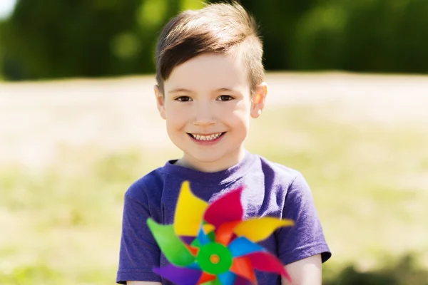 Happy little boy with colorful pinwheel at summer — Stock Photo, Image