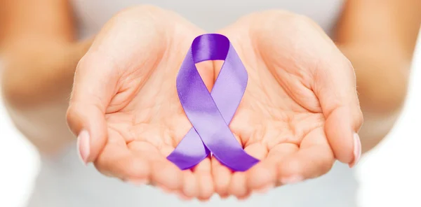 Hands holding purple awareness ribbon — Stock Photo, Image