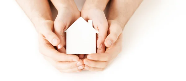 Man and woman hands with white paper house — Stock Photo, Image