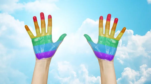 Palms of human hands painted in rainbow colors — 스톡 사진