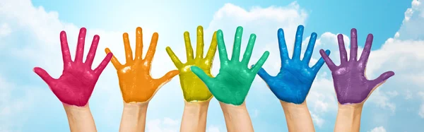 Palms of human hands painted in rainbow colors — Φωτογραφία Αρχείου
