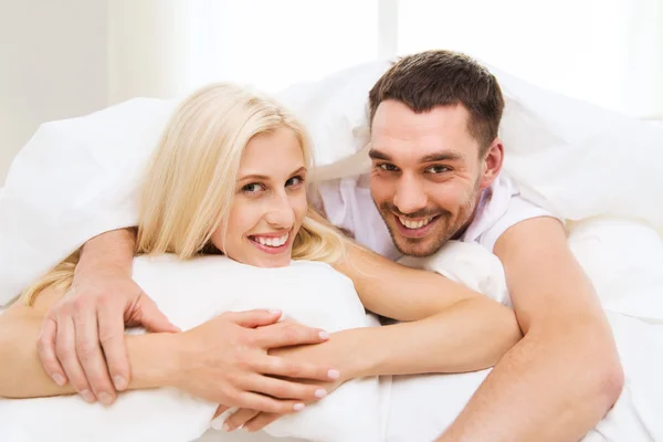Happy couple in bed at home Royalty Free Stock Images