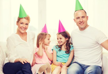 happy family with two kids in hats celebrating clipart