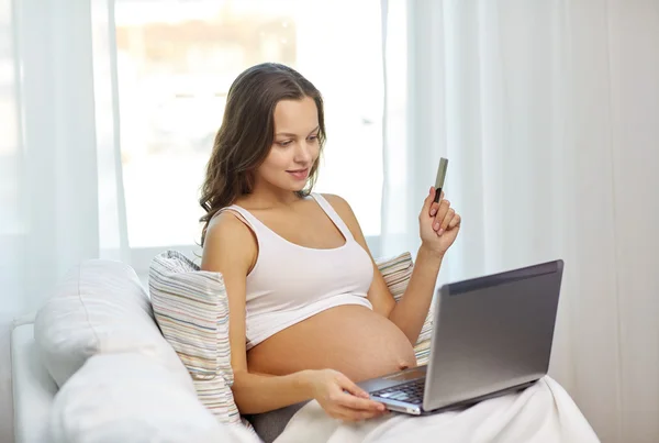 Pregnant woman with laptop and ultrasound image — Stock Photo, Image