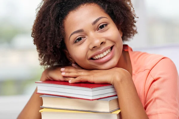 Happy african student girl with books at home Stock Picture