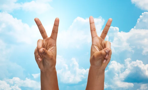 Two african hands showing victory or peace sign — 스톡 사진