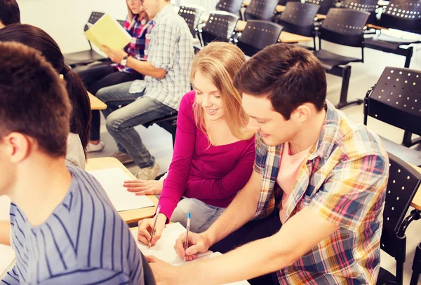 Group of smiling students in lecture hall — Stock Photo, Image