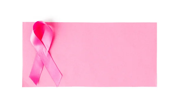 Close up of pink cancer awareness ribbon on paper — Stock Photo, Image