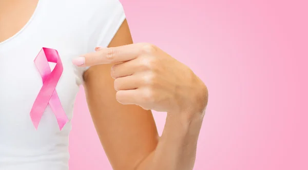 Close up of woman with cancer awareness ribbon — Stock Photo, Image