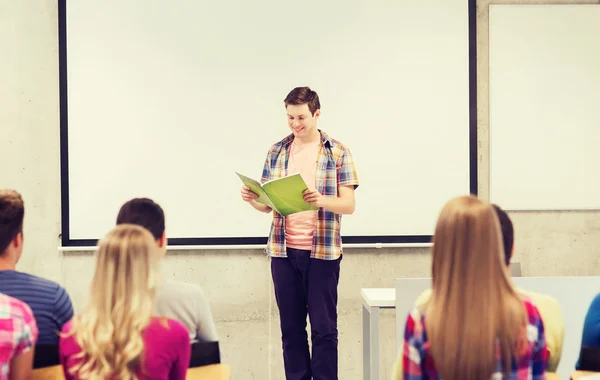 Group of smiling students in classroom — Stock Photo, Image