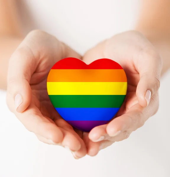 Female hands with small rainbow heart — Stock Photo, Image