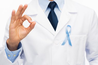 happy doctor with prostate cancer awareness ribbon clipart