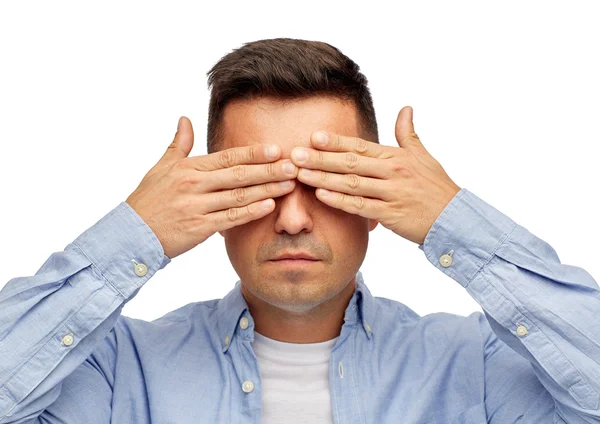 Face of man covering his eyes with hands — Stockfoto