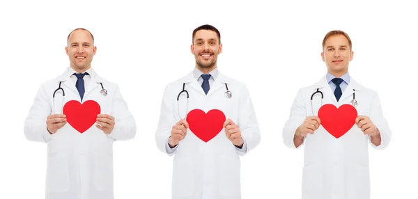 Tres doctores varones sonrientes con corazones rojos — Foto de Stock